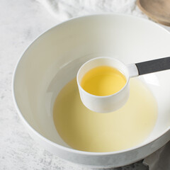 overhead view of Vegetable oil in a measuring cup, top view of vegetable oil for baking
