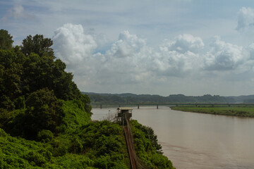 Military Watchtower Overlooking Calm River And Green Landscape With Bridges And Rolling Hills Under Cloudy Sky