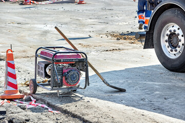 Construction site with generator and equipment on a sunny day in an urban setting. Copy space.