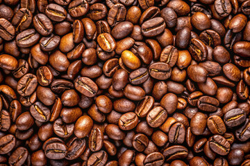 Fototapeta premium Aromatic Roasted Coffee Beans: A close-up shot of freshly roasted coffee beans, showcasing their rich, deep brown color and enticing texture, evoking the warmth and inviting aroma of a perfect cup.