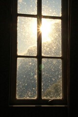 Morning sunlight peeking through dirty windowpane, clouds, light