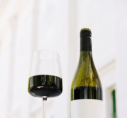 Enjoying a glass of red wine at a stylish outdoor setting