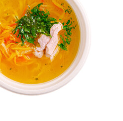 Warm chicken broth with fresh vegetables and herbs in a bowl
