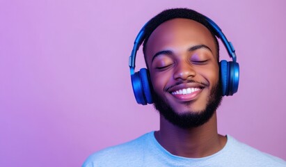 Modern and cool man listening music on headphones with smiley and happy attitude on trendy color background