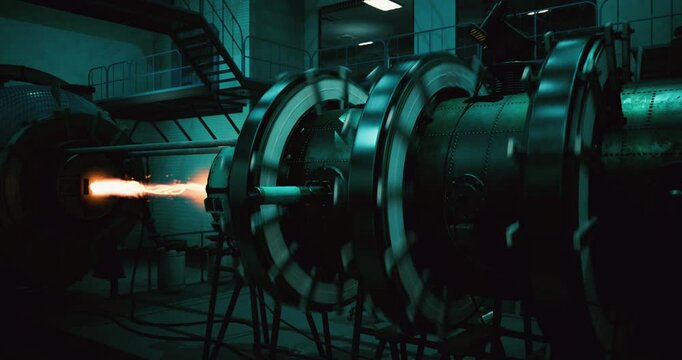 A fuel ignition in a rocket engine test setup highlights advanced technology and engineering. The intense flame bursts from the nozzle, demonstrating high pressure and precision.