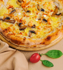 Freshly baked chicken and mushroom pizza on wooden board