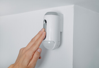 man connecting the camera of a burglar alarm