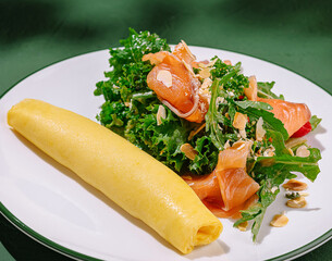 Savory crepe served with fresh salad and smoked salmon