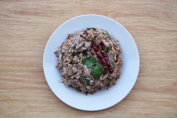 Homemade spicy young jackfruit salad, mixed with herbal food ingredient, serve in dish. Concept, local traditional food in Thailand. Delicious healthy menu. Top view.   