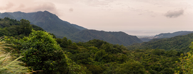 Expansive Mountain Landscape Overlooking Dense Green Forest and Distant Coastline in Taiwan