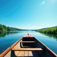 Obraz premium A wooden rowboat glides across the lake under a clear blue sky, peaceful, nature, sky