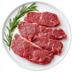 Fototapeta premium Raw beef steaks on a plate with rosemary.
