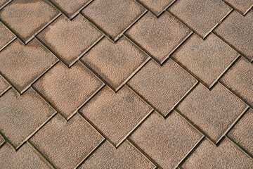 Brown terra cotta floor tiles. Anti-slip brown stone tiles for outdoor flooring. Selective focus