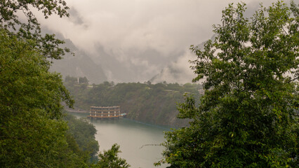 Floating Structure on Misty Mountain Lake Surrounded by Lush Greenery and Steep Cliffs in Taiwan’s Remote Wilderness