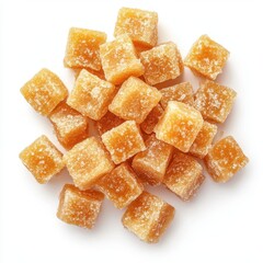 Delicious golden brown candied ginger cubes, close-up overhead shot.