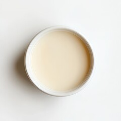 Overhead View of Creamy Beige Liquid in a Small White Bowl.