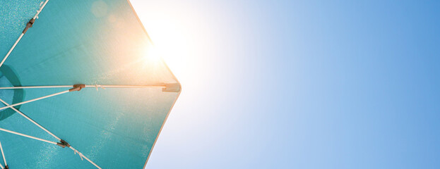 beach sun umbrella on blue summer sky