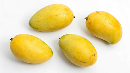 Fresh, ripe mangoes with a mix of yellow and red hues, arranged on a clean white surface.