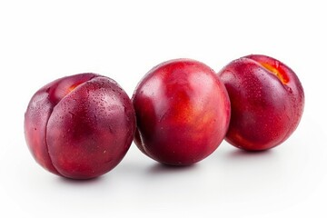 Obraz premium Trio of red plums on white background. AI image