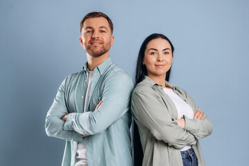 Standing with arms crossed. Man and woman are in the studio
