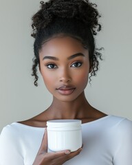 A beautiful Black woman in a white shirt holds a skincare cream jar, promoting beauty and self-care.