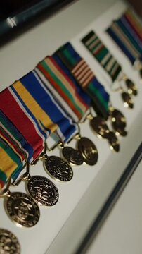 Closeup of military medals display in a row, highlighting honors and achievements