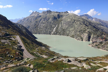 The Grimsel Pass road in the Bernese Alps. View of the artificial lake Grimselsee - hydroelectric reservoir for Grimsel Pass Dam. Municipality of Guttannen, Canton of Bern, Switzerland