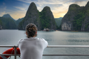 Fototapeta premium Man watching Beautiful landscape of Cat Ba Island. Lan Ha bay is the UNESCO World Heritage Site.