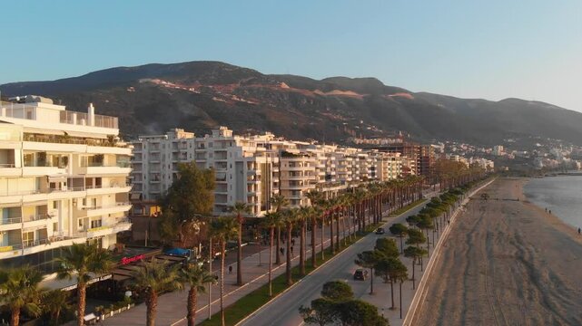 Vlora, albania at sunset with urban landscape and surrounding hills in the distance, aerial view