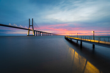 Vasco da Gama bridge and pier over tagus river in Lisbon, Portugal, before sunrise