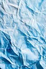 Obraz premium Textured wrinkled blue paper background for creative design projects