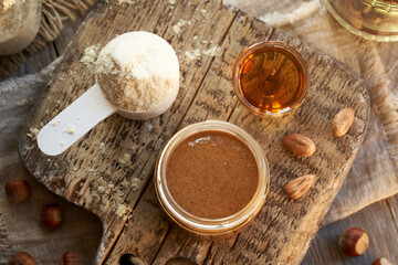 Homemade hazelnut butter, whey protein powder and maple syrup - ingredients for healthy protein snack bars