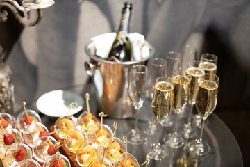 champagne poured into glass goblets at a banquet