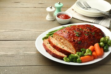 Delicious baked turkey meatloaf with vegetables served on wooden table, closeup. Space for text