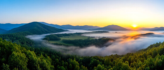 Fototapeta premium A stunning panorama of a misty valley at sunrise, surrounded by rolling mountains and lush greenery, creating a serene and tranquil atmosphere.
