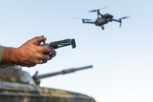 artillery spotter or military observer launches drone into sky force reconnaissance in enemy territory. drone control panel is in hand of military soldier. Modern technological reconnaissance warfare