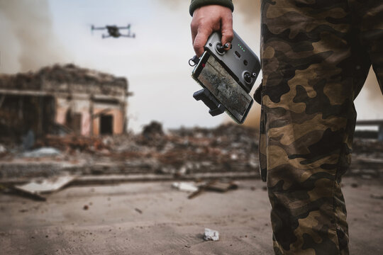 artillery spotter or military observer launches drone into sky force reconnaissance in enemy territory. drone control panel is in hand of military soldier. Modern technological reconnaissance warfare