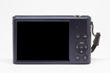 Blue digital camera from back, isolated on white, black empty screen