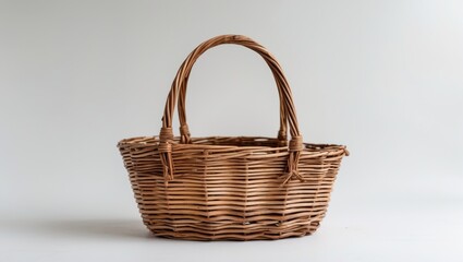 Woven wicker basket with two handles on a plain background front view
