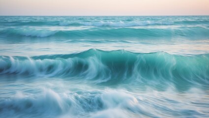 Fototapeta premium Waves crashing on the shore at sunset with soft turquoise and white colors creating a serene coastal landscape