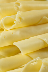 Semi-hard cheese, thin slices, rolled into tubes.