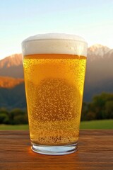 Effervescent Golden Beer Pint on Wooden Table with Mountainous Backdrop in Tranquil Ambiance