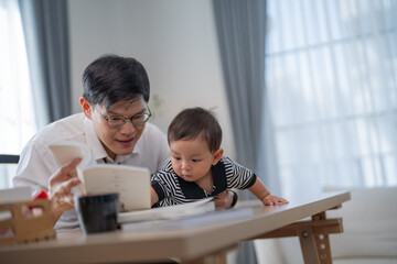 Fototapeta premium Father and toddler engaged in playful learning at home during a sunny afternoon