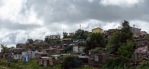 South Africa informal settlement on a hill, houses made of corrugated metal sheet and cardboard