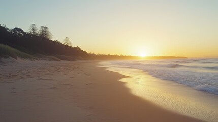 Obraz premium Serene Beach Sunset Over Gentle Waves and Coastline Landscape