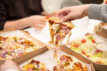 Pizza with mozzarella cheese topped with sliced onion, sausage with pickles.