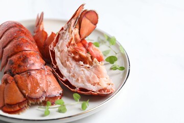 Delicious tails of boiled lobsters served on white table, closeup. Space for text