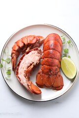 Delicious tails of boiled lobsters served on white table, top view