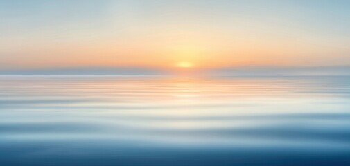 Obraz premium A serene seascape at sunrise, capturing the calm waters reflecting soft pastel hues. This tranquil image evokes a sense of peace and connection with nature.