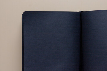 Flat Lay of Open Black Blank Notebook on Brown Surface